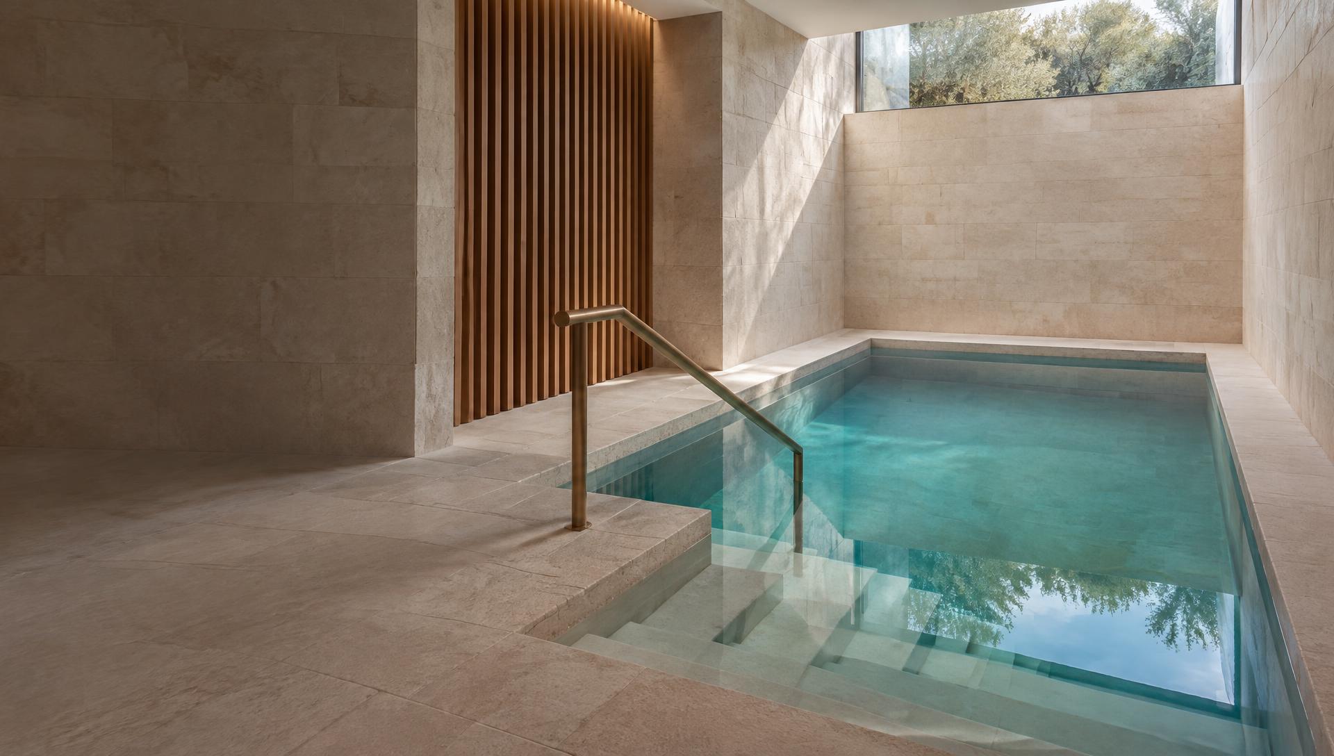 Architectural concept of a mikva with clear water, carefully built stone steps, and natural light